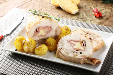 Roulade of stuffed chicken with potatoes and rosemary