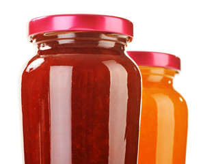 Two jars of fruity jams isolated on white. Preserved fruits
