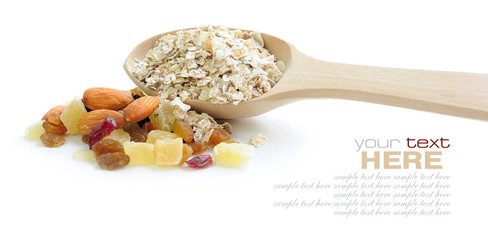Oat flakes in wooden spoon with mix nuts and dry fruits on white