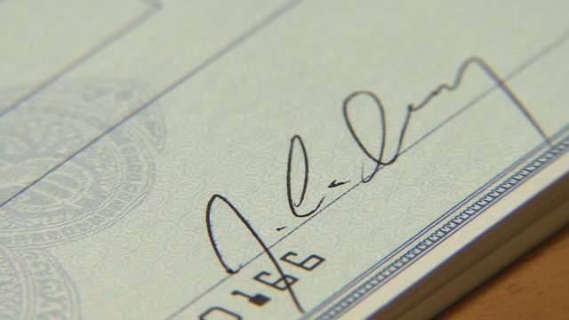 Writing a Bank Check, signing a bank check