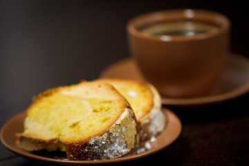 Round cake slice with sugar top and coffee. Traditional cuisine.