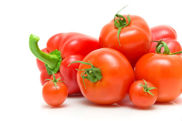 fresh vegetables - tomatoes and peppers on a white background