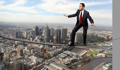 Balancing businessman and cityscape