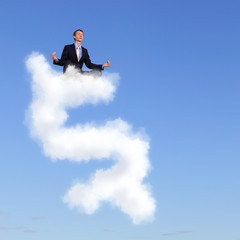 Businessman meditating sitting on the cloud