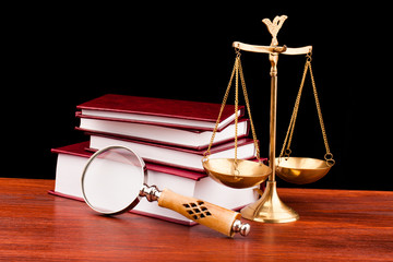 books of justice ,scale and magnifying glass