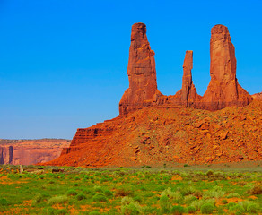 Monument Valley landscape with rock formations and blue sky