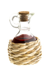 Small decanter with red wine vinegar isolated on the white