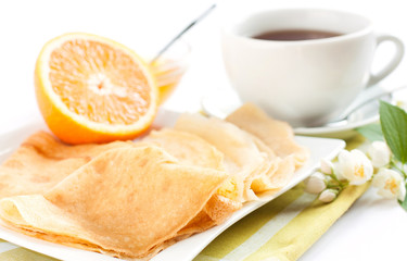 pancakes topped with orange juice and tea