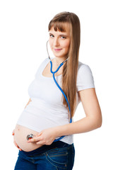 Pregnant woman listening to belly stethoscope