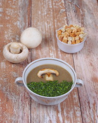 Mushroom soup with croutons on a wooden background