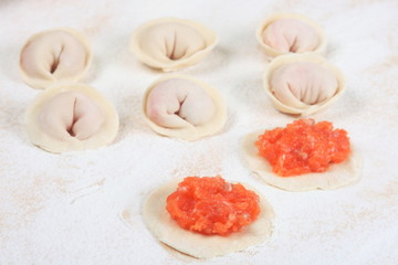 Homemade fish dumplings on a cutting board close-up