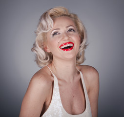 Pretty blond girl model like Marilyn Monroe in white dress