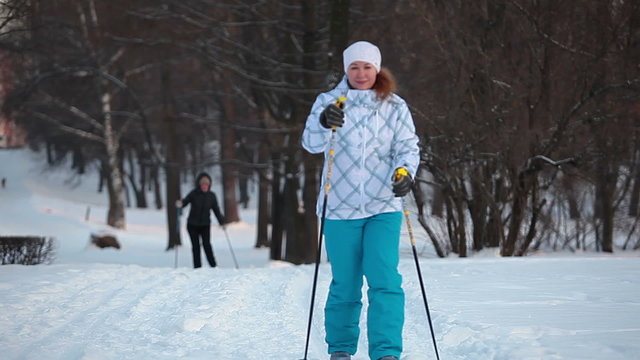 Woman sportsman on ski in city park