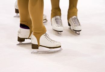 Closeup of figure skating ice skates in action