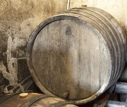 Big vintage wood barrel in old traditional wines cellar