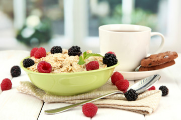 tasty oatmeal with berries and cup of tea