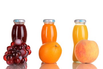 Delicious grapes, orange and apple juice in glass bottle and