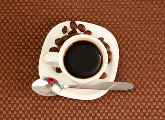 Cup of coffee on brown background