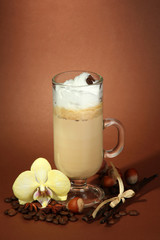 Fragrant coffee latte in glass cup with spices,