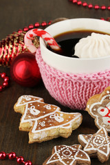 Cup of coffee with Christmas sweetness on wooden table close-up