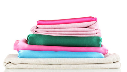 Pile of different fabrics isolated on white