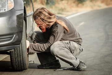 Young man repairing car outdoors