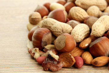 assortment of tasty nuts on wooden background