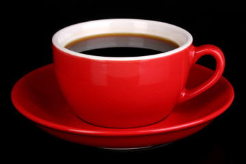 A red cup of strong coffee isolated on black