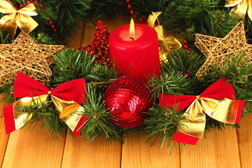 Fototapeta na wymiar Christmas composition with candle and decorations in red and