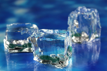 Ice cubes on blue background close-up