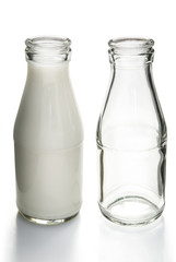 full and empty milk bottles with clipping path