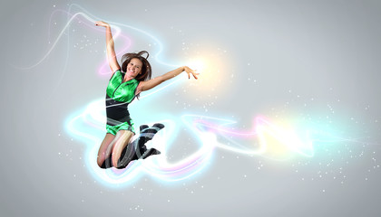 Fototapeta na wymiar Young woman dancer. With lights effect.