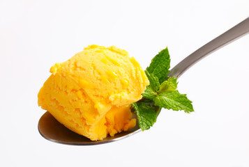 Yellow ice cream on spoon