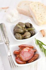 sausages with olives in the bowl and bread