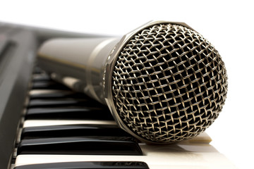 Microphone and electronic keyboard.  Are isolated on a white bac