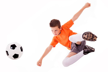 Fototapeta premium Boy making a acrobatic kick with soccer ball, isolated on white