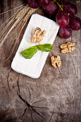 White goat cheese with noble rot on wooden table