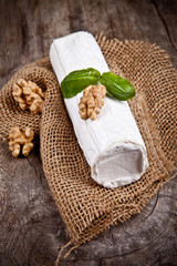 White goat cheese with noble rot on wooden table