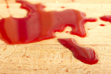 Blood spill on a wooden surface close-up