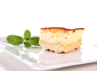 Piece of cheesecake decorated with mint