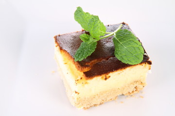 Piece of cheesecake decorated with mint