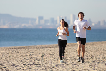 Man and woman running in the beach