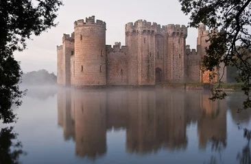 Wall murals Castle Stunning moat and castle in Autumn Fall sunrise with mist over m
