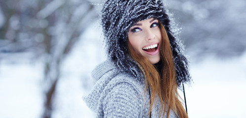 Girl playing with snow in park