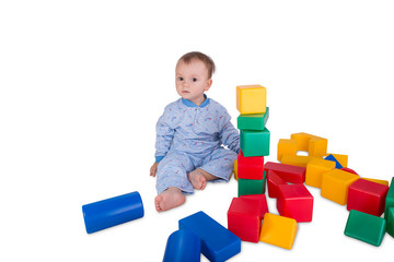 child playing with plastic blocks and cubes
