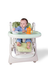 child is eating sitting at table, isolated over white