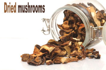 Dried mushrooms spilling out of a storage jar 