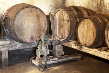 Interior of very old wine cellar with vintage wine pump