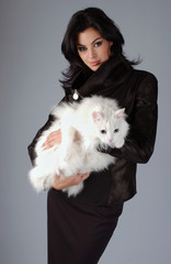 Portrait of sophisticated brunette woman with white Cat