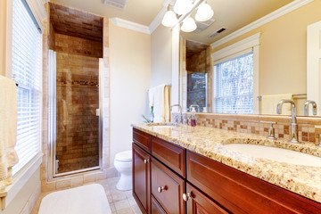 Large bathroom with cherry cabinets and granite countertop.